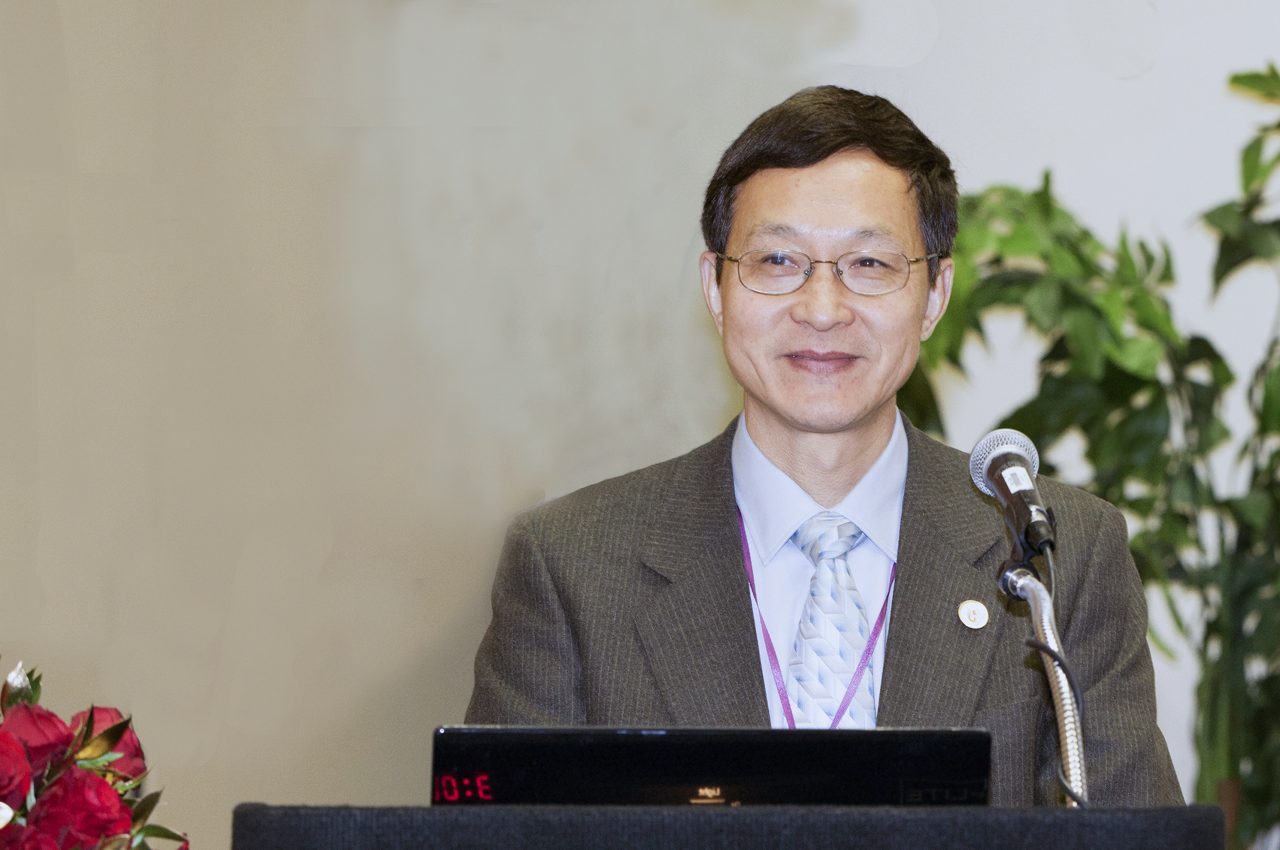 Dr. Shen at a conference speaking